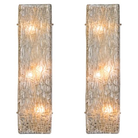Again, wall lights that work as backlighting are taking the stage to bring a stylish glow to a hallway, staircase, or living room. Pair of Murano Glass Wall Sconces For Sale at 1stdibs