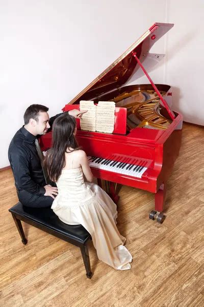 Couple Playing The Red Piano Stock Image Everypixel