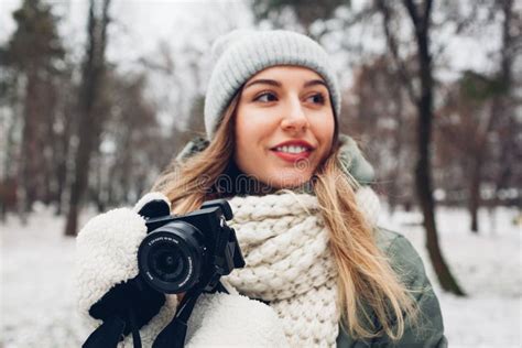 Woman Photographer Takes Pictures Of Snowy Winter Park Using Camera