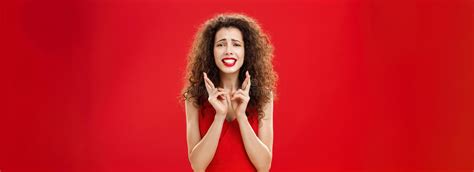 Concerned Insecure Hopeful Woman With Curly Hair In Red Lipstick And Stylish Dress Clenching