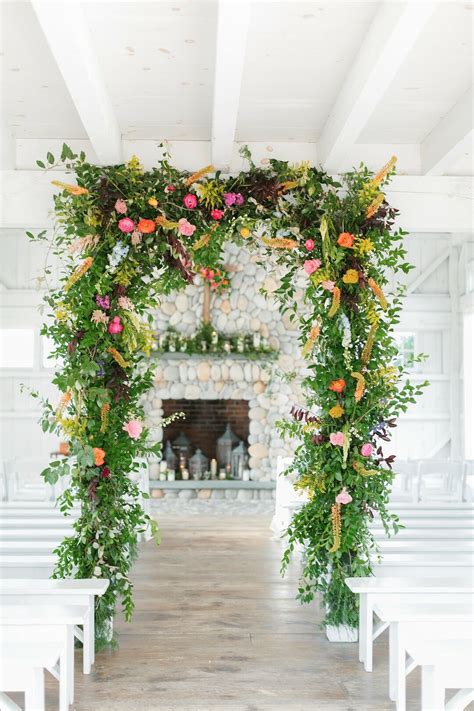 Whimsical Greenery Wedding Arch With Colorful Flowers