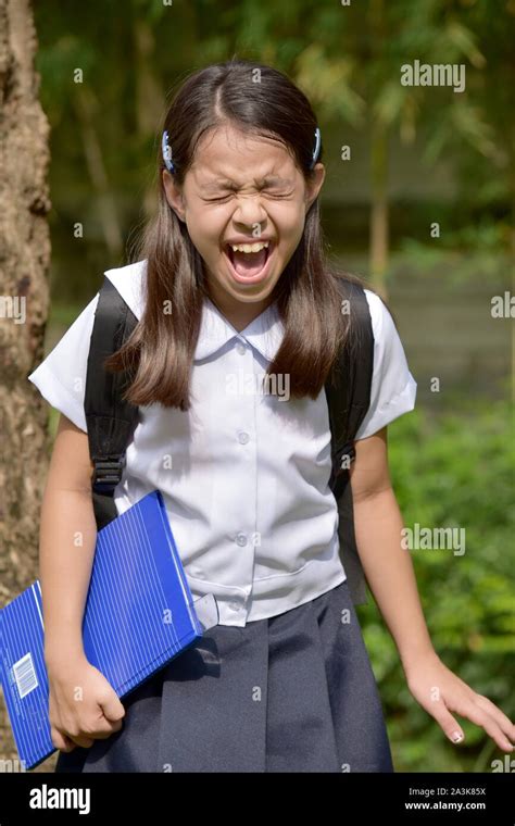 Stressful Young Diverse School Girl Wearing School Uniform Stock Photo