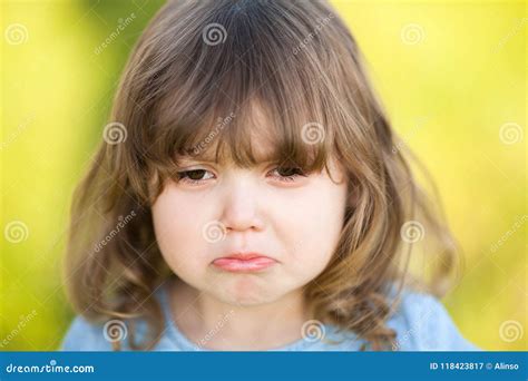 Adorable Little Girl With Sad Expression Of Her Face Going To Cry