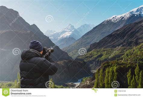 Photographer Taking Photograph Of Hunza Valley Landscape In Pakistan By