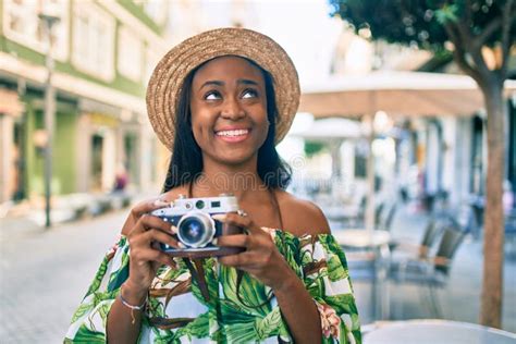 Young African American Tourist Woman On Vacation Smiling Happy Using