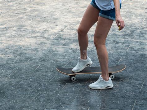 The Girl Rides A Skateboard Legs And Skateboard Close Up Stock Image