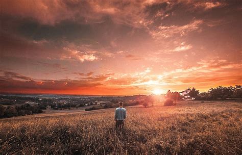 Hd Wallpaper Man Standing On Grass Field During Golden Hour Sunset