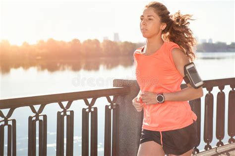 Runner Is Jogging In Sunny Bright Light On Sunrise Stock Photo Image