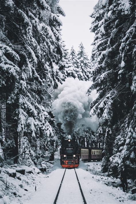 A Train Traveling Through A Snow Covered Forest