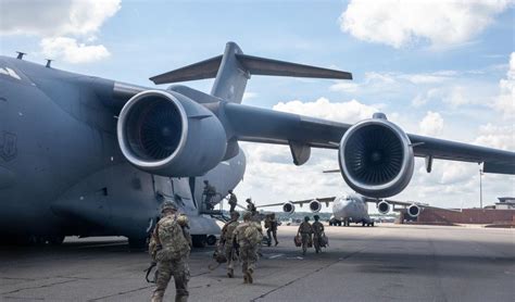 Joint Base Charleston Crews Load Troops Vehicles Onto C 17s To Aid