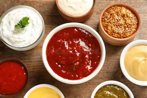 Set Of Different Delicious Sauces On Wooden Table Stock Photo Image