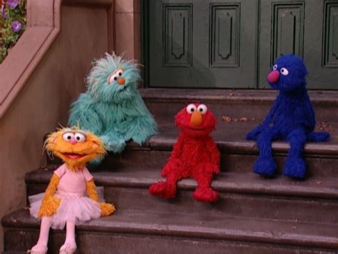 Three Sesame Street Characters Sitting On The Steps