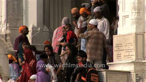 Indian Sikh Pilgrims Bathe In The Holy Sarovar At The Golden Temple