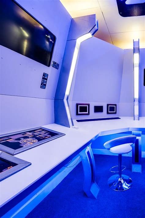 The Interior Of A Futuristic Space Station With Blue Carpet And White