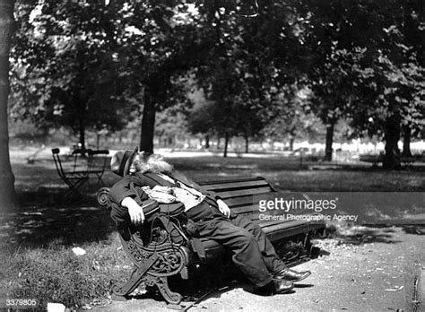 Homeless Man Sleeping On Park Bench Bandw Photos And Premium High Res