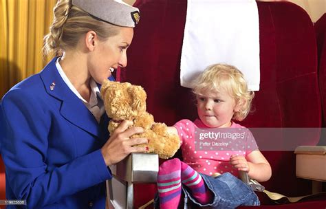 Air Hostess Entertaining Child On Airplane High Res Stock Photo Getty