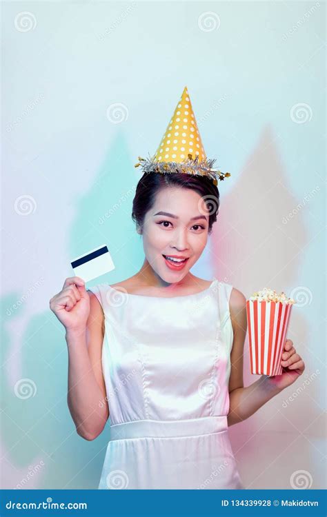 Portrait Of Young Overjoyed Attractive Woman In White Dress Watching Movie Film Holding Bucket