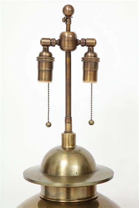 The lamp has a wood base with a mahogany finish and features a ginger jar shape with a blue and white motif. Pair of Large Brass Ginger Jar Lamps at 1stdibs