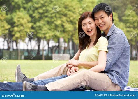 Young Chinese Couple Relaxing In Park Together Stock Photo Image Of