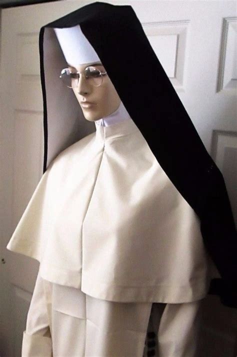 A Mannequin Dressed In White And Black With A Nuns Hat On