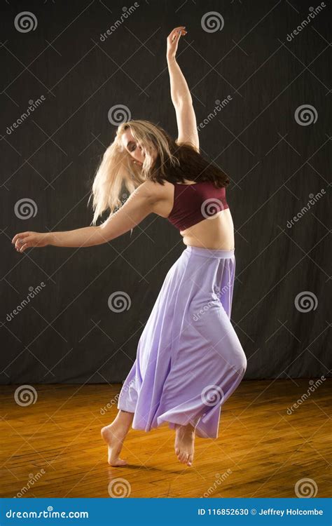 Young Woman Dancing In The Studio On A Hardwood Floor Stock Photo