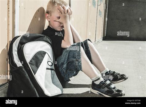A Very Sad Boy In School Playground Stock Photo Alamy