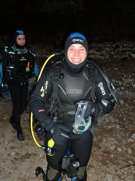 two men in wetsuits and scuba gear standing next to each other