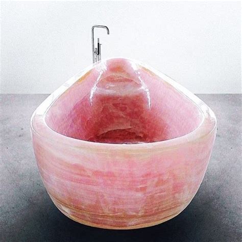 A Pink Bowl Sink Sitting On Top Of A Counter