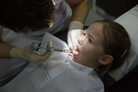 Scared Little Girl At Dentist Office Getting Local Anesthesia