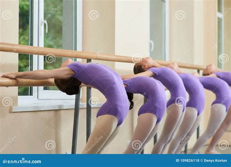 Young Ballerinas Stretching At Ballet Barre Stock Photo Image Of