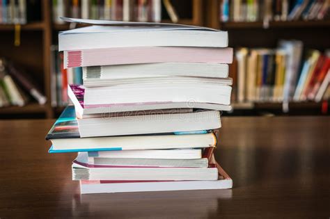 Pile Of Books In A Library And Bookshelf Stock Photo Image Of