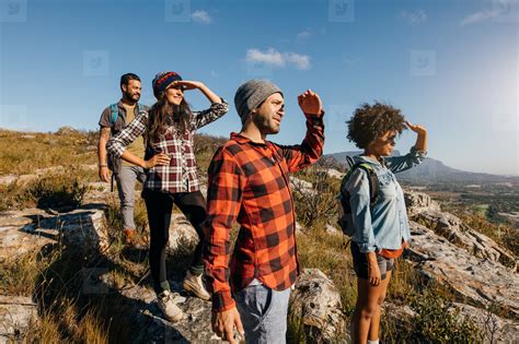 Group Of Hiking Friends Enjoying The View From Mountain Peak Stock