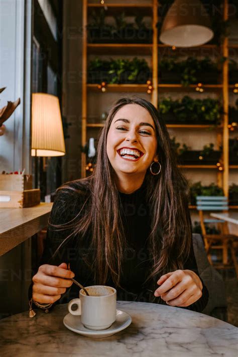 Delighted Woman Drinking Coffee In Cafe Stock Photo