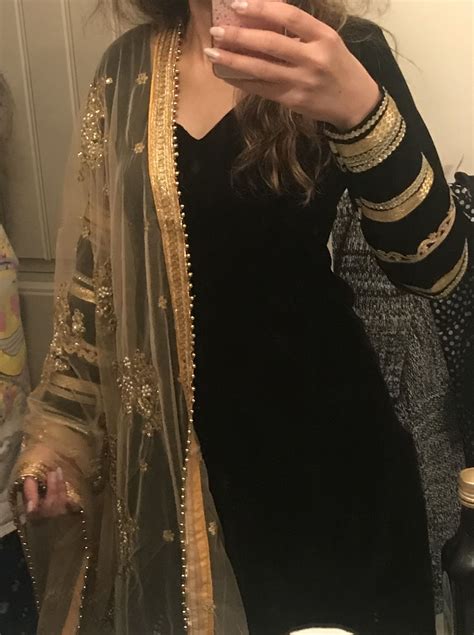 Elegant Punjabi Suit In Black Velvet With Golden Laces On Arms And Golden Embroidered Dupatta