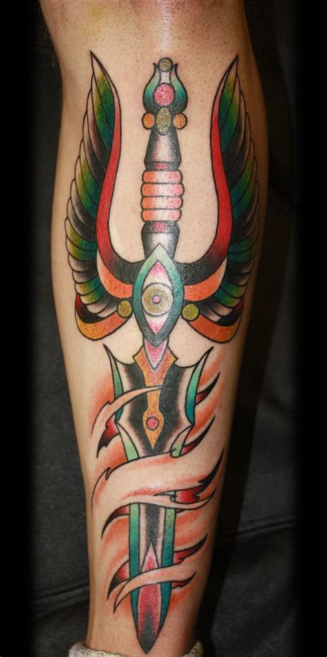 winged dagger pierces skin forearm tattoo by miles kanne tattooimages
