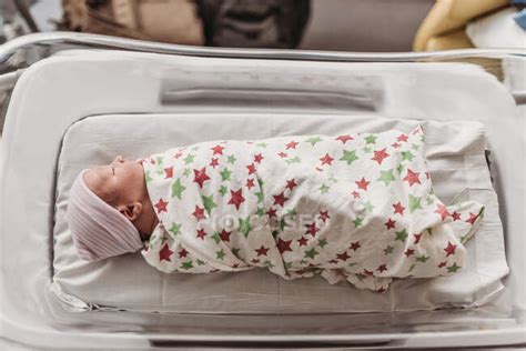 Newborn Baby Boy In Bassinet Wrapped In Hospital Blanket — Inside