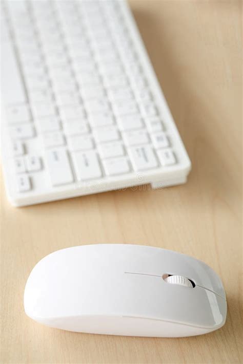 Wireless Mouse And Keyboard Set On Top Of A Wooden Office Desk Stock