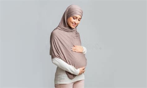 Pregnant Muslim Woman Suffering Prenatal Contractions Caring Husband Making Shoulder Massage