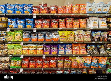 Grocery Store Shelves With Bags Of Junk Food Snacks For Sale Stock