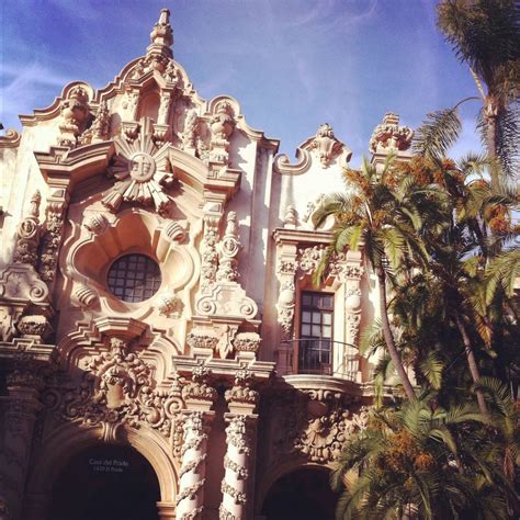 An Ornate Building With Many Windows And Palm Trees