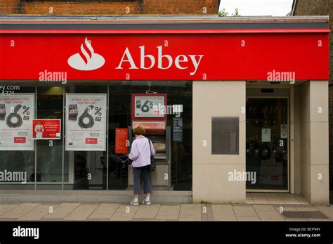 Abbey Bank Branch With A Woman At A Cashpoint Stock Photo Alamy