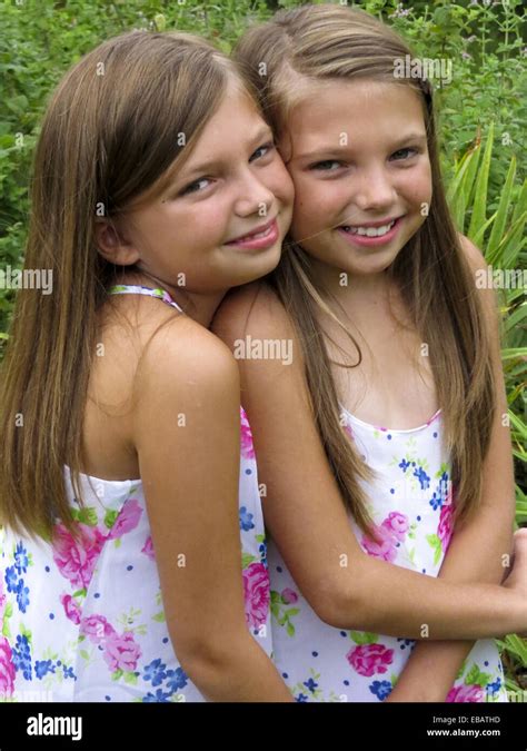 Fraternal Twin Sisters Hugging Stock Photo Alamy
