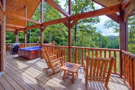 A Covered Deck With Rocking Chairs And Hot Tub On The Other Side