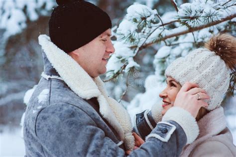Winter Portrait Of Happy Romantic Couple Enjoying Their Walk In Snowy Forest Or Park Stock Image