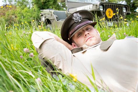 Handsome American Wwii Gi Army Officer In Uniform Relaxes In A Meadow