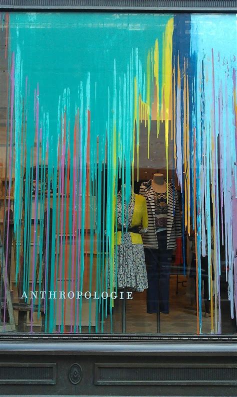 Two People Standing In Front Of A Store Window With Colorful Streamers