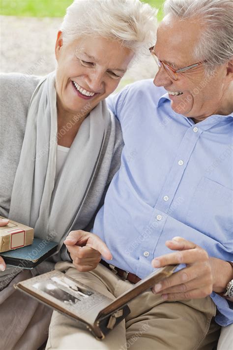 couple looking through photo album stock image f013 6437 science photo library