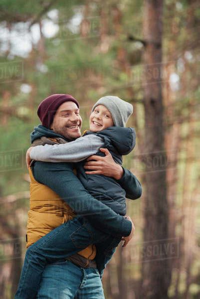 Happy Father And Son Hugging In Autumn Forest Stock Photo Dissolve