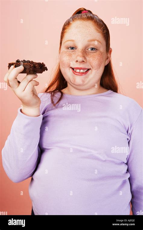 Overweight Girl 13 15 Smiling Holding Brownie Portrait Front View