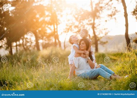 Mother And Two Daughters Having Fun In The Park Happiness And Harmony